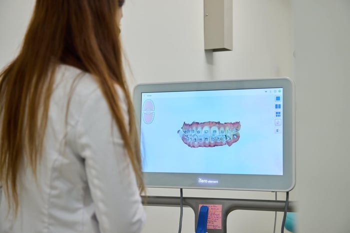A woman looking on a monitor