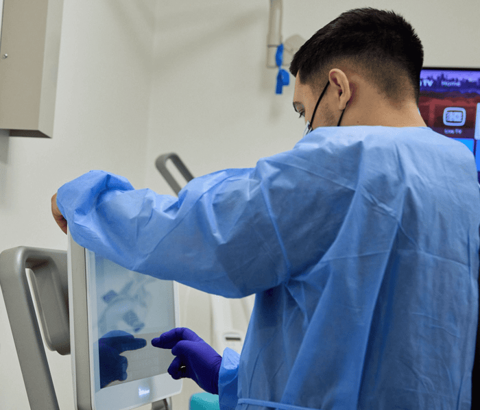 A person pointing on a monitor