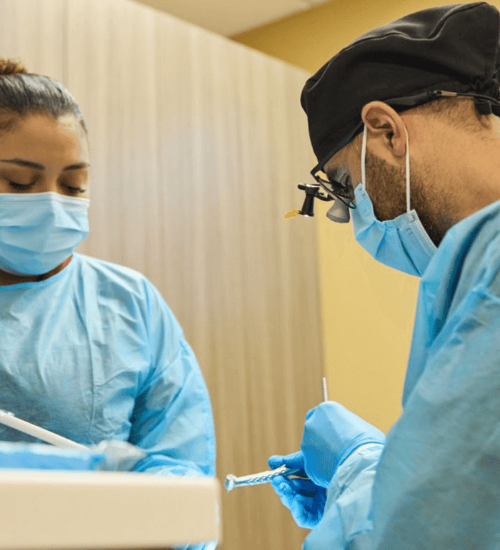 Two dentist working on a patient