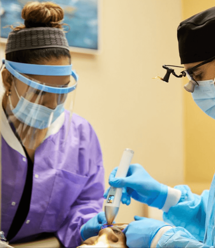 Two dentist working on a patient