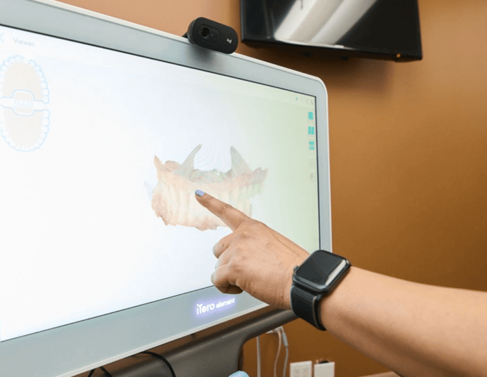 A person pointing on a monitor