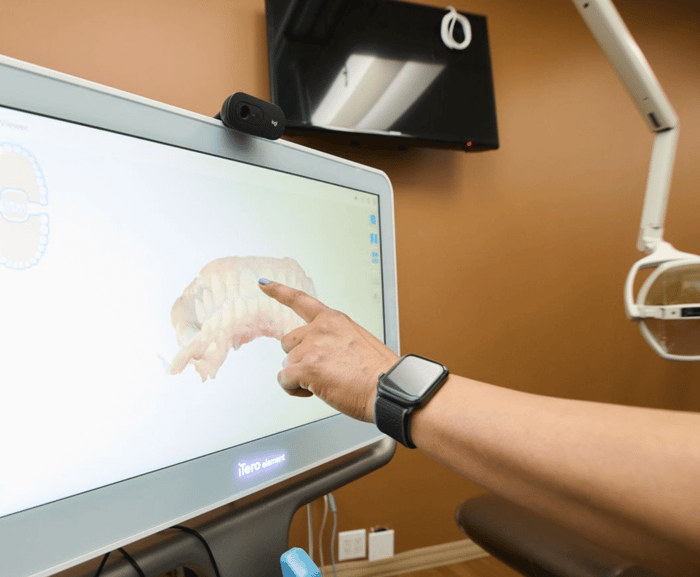 A person pointing on a monitor