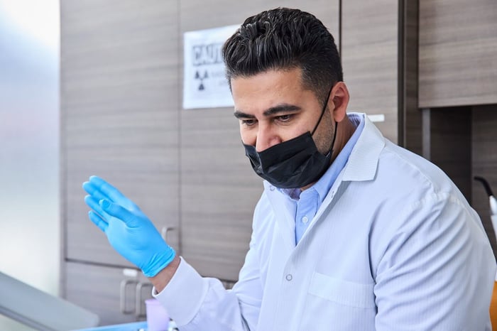 A person wearing a face mask and a gloves