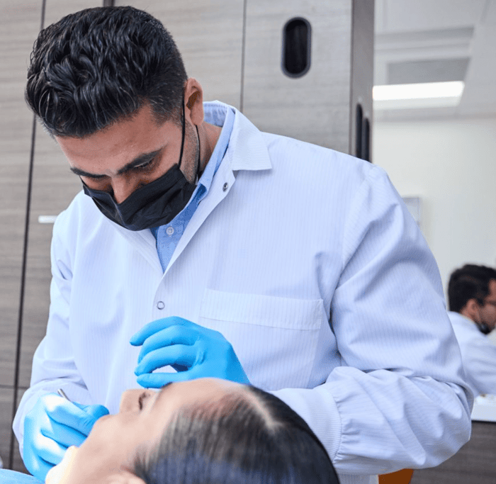 A person wearing a face mask and a gloves