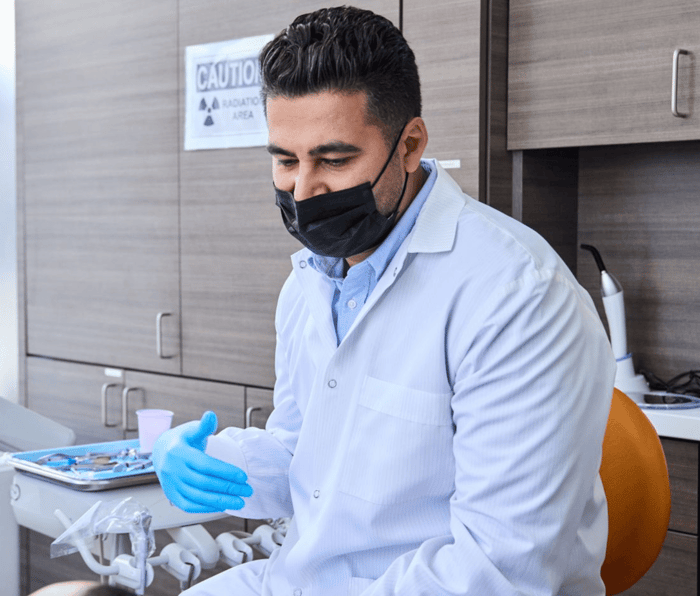 A person wearing a face mask and a gloves