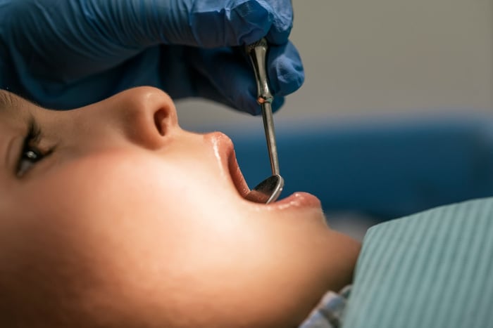 A person being checked on the teeth