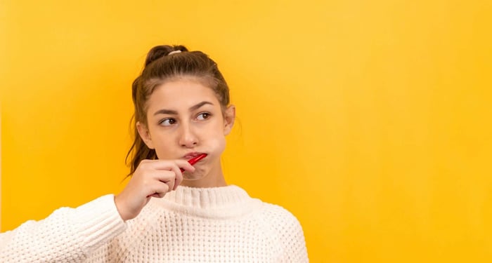 Teen brushing teeth, highlighting common reasons gums bleed when brushing and the importance of maintaining healthy gums.