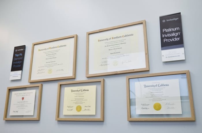A wall full of frames of certification