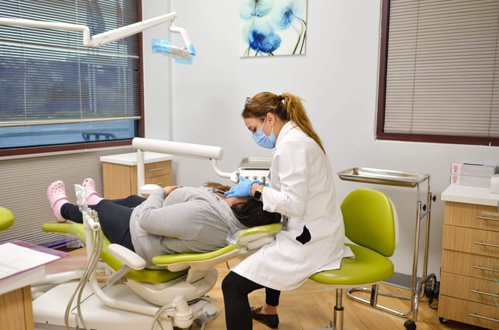 A photo of a dentist working on a patient