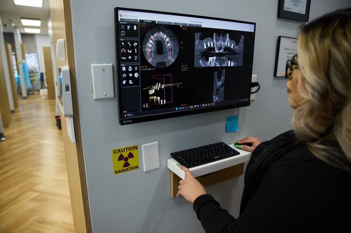A woman in front of a monitor