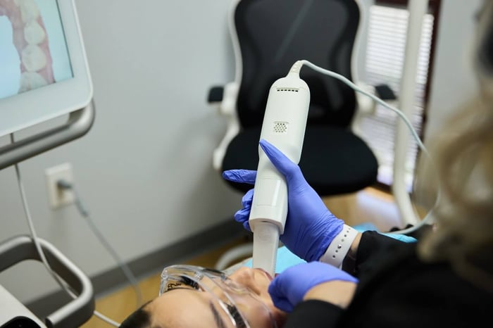 A person working on a patient's teeth