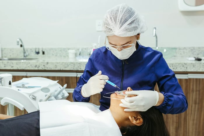 A woman working on a patient