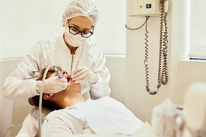 A woman working on a patient