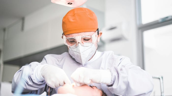 A dental person working on a patient