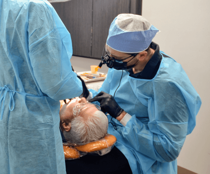 Two person working on a patient
