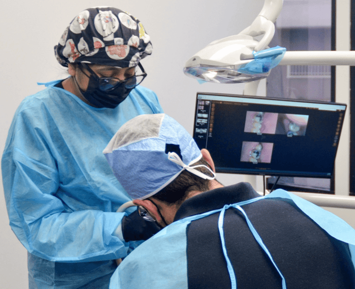 Two person working on a patient