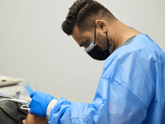 A person wearing a blue scrub