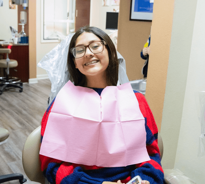 A woman with braces smiling