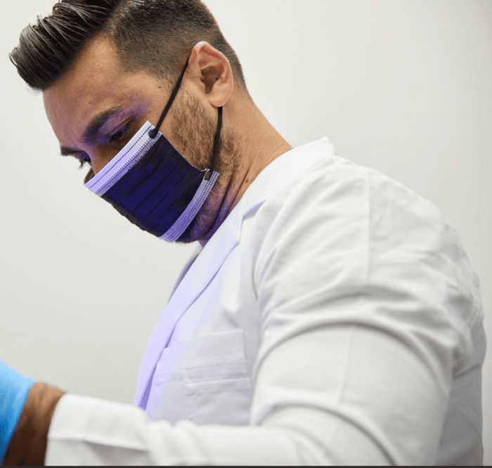 A person wearing a face mask and a gloves