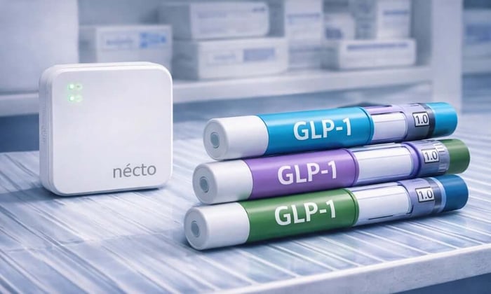 Necto temperature monitor placed on a pharmacy refrigerator shelf beside three color-coded GLP-1 medications injection pens, representing proper GLP-1 medication storage conditions.