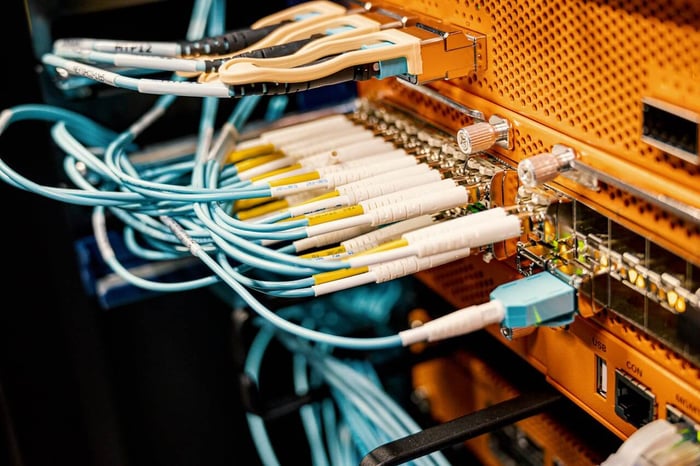 Small edge IDF closet showing how to monitor a remote server room using a cellular sensor plugged in near wall-mounted network equipment.