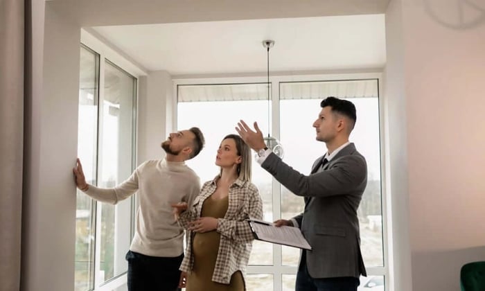 Property manager showing tenants potential property challenges during a walkthrough of a multi-unit rental