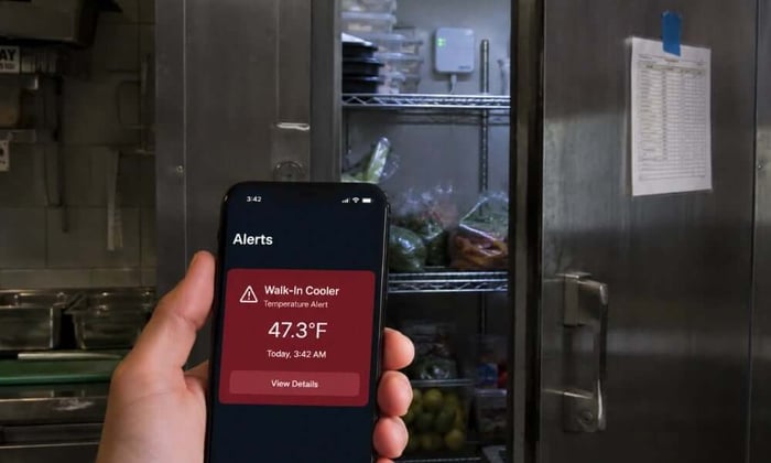 Cellular temperature sensor inside restaurant walk-in cooler for restaurant food poisoning prevention monitoring.