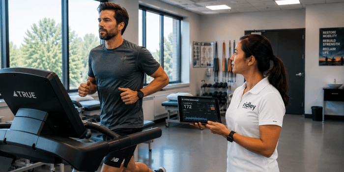 Runner on treadmill with physical therapist providing cadence feedback during gait retraining for runners with patellofemoral pain