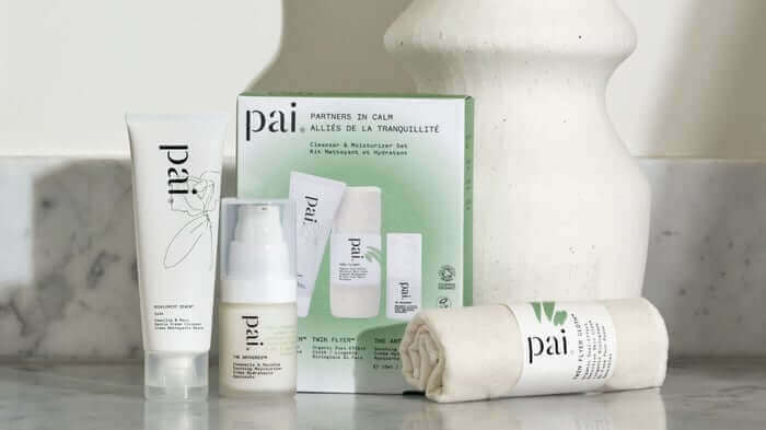 Pai Skincare Partners in Calm collection displayed on marble surface featuring cleanser, serum, moisturizer and gift set for sensitive skin