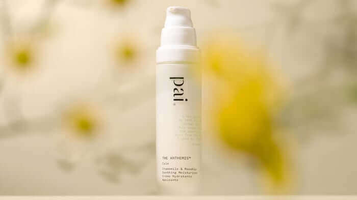 Pai Skincare The Anthemis moisturiser pump bottle against soft yellow floral background, ideal face cream for sensitive skin