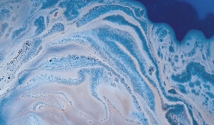 Blue and white swirled cleanser foam texture representing oily skin cleansing process