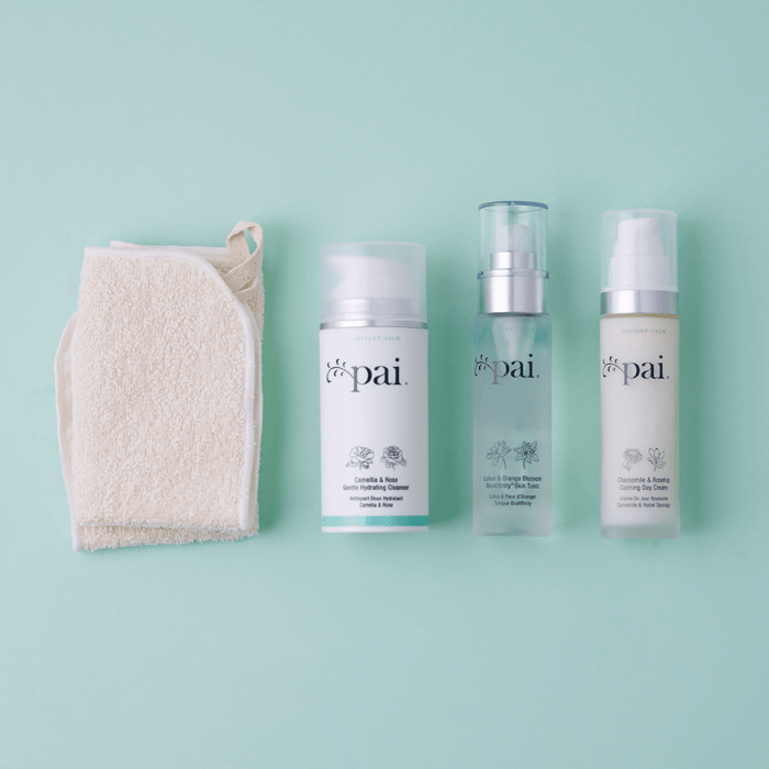 Pai skincare cleanser, tonic and day cream arranged with muslin cloth on sage green background