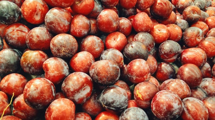 Fresh umeboshi plums with vibrant red and mottled skin rich in antioxidants for skincare benefits