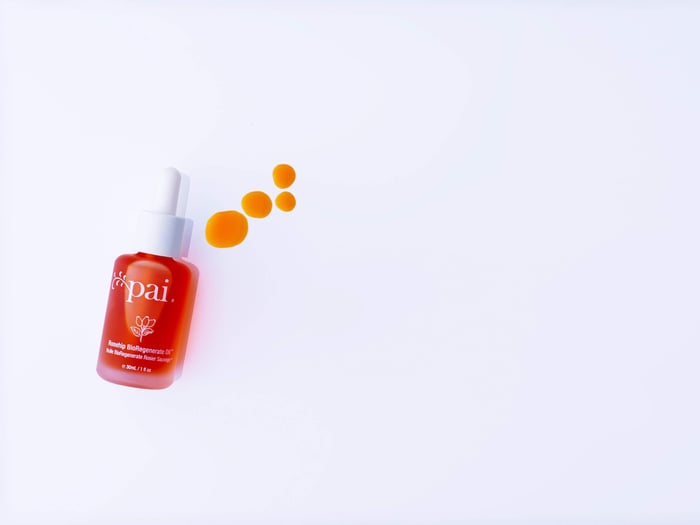 Pai Rosehip BioRegenerate Oil with golden droplets showing oil application technique