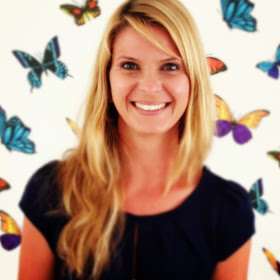 Marine, Pai's formulation chemist and fragrance specialist, smiling against colorful butterfly backdrop