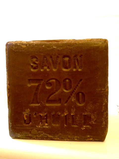 Natural olive oil soap bar stamped with SAVON 72% showing traditional French soap craftsmanship