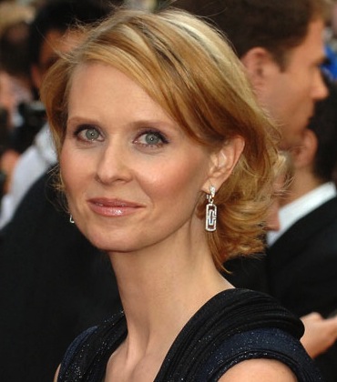 Cynthia Nixon with glowing complexion at red carpet event, showcasing confidence despite rosacea journey