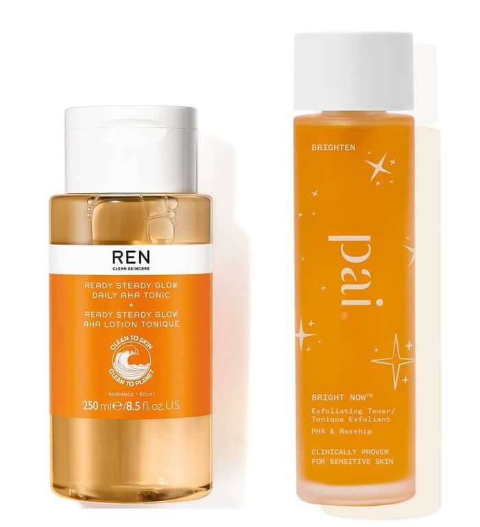 REN Ready Steady Glow AHA Tonic bottle next to Pai Skincare Bright Now PHA exfoliating toner showing orange liquid formulations