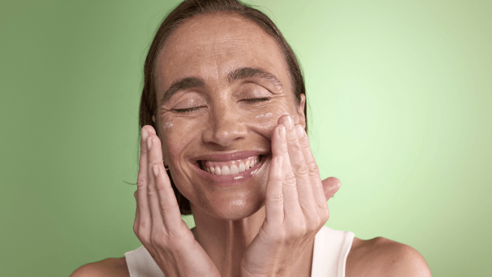 Model face with a moisturiser texture on her skin. It's Pai Skincare PDRN Moisturiser.