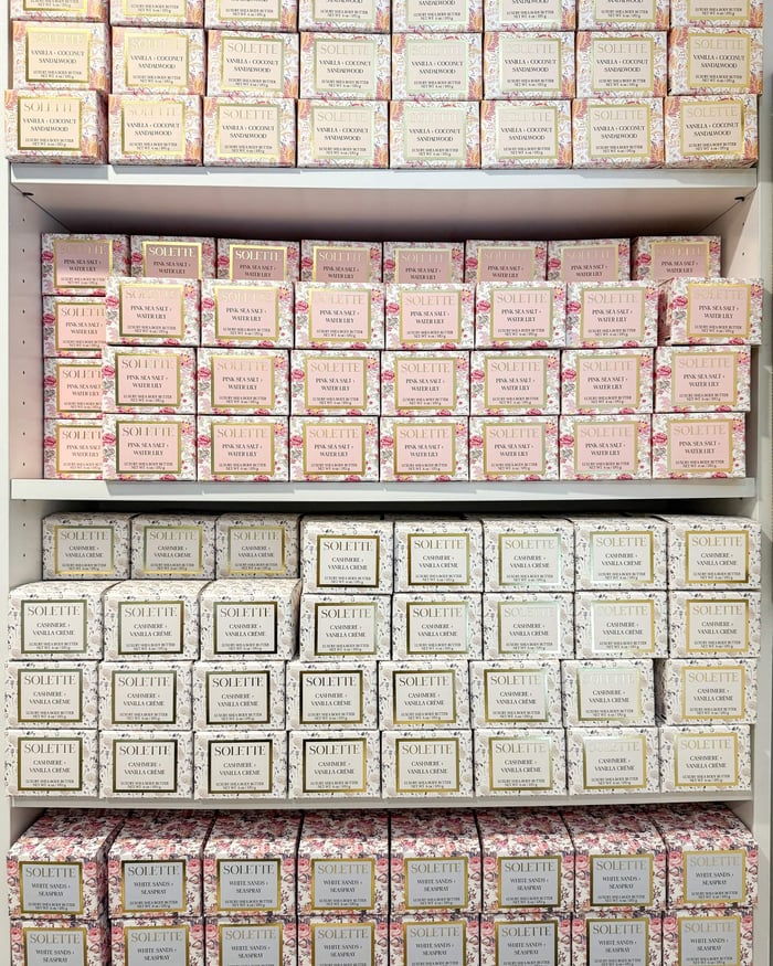 what makes a body butter greasy? a shelf filled with stacked body butter boxes