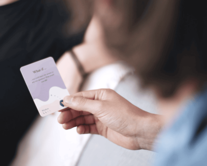 A facilitator holding Scenario Cards while leading an advanced conversation group.
