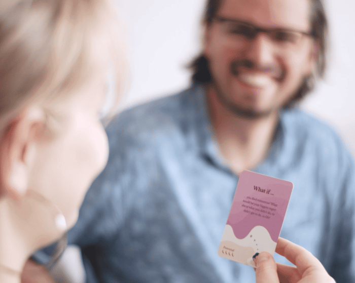 A happy couple playing Scenario Cards to build intimacy and move beyond digital distractions.
