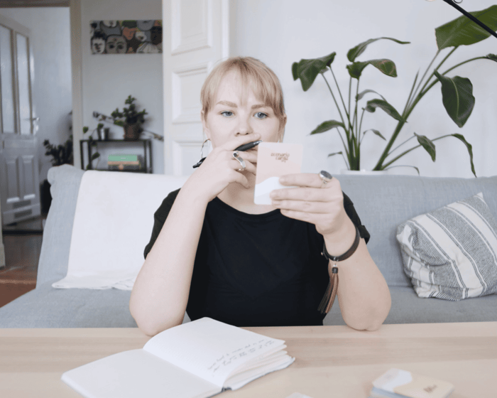 A woman using Scenario Cards as journaling prompts to spark deeper self-reflection.