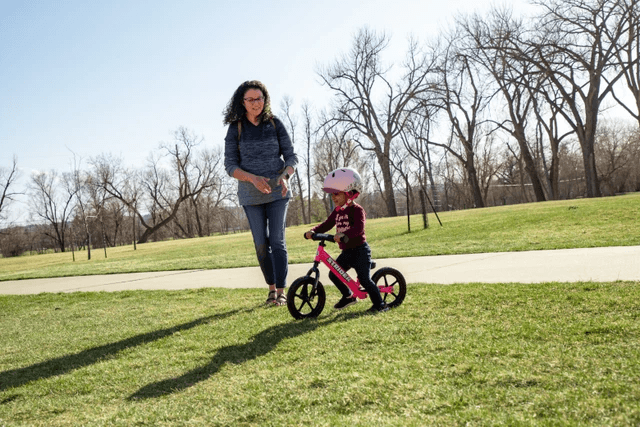 How do I teach my toddler to ride their balance bike?