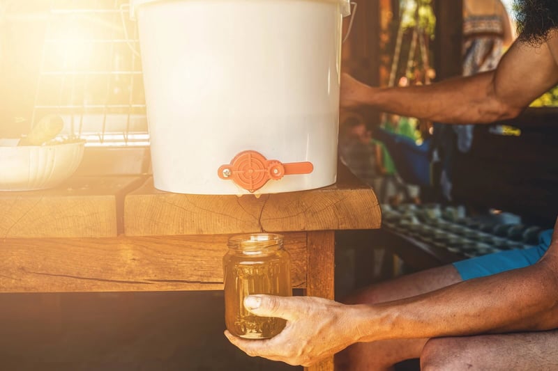 Honey being bottled into a glass jar for proper storage
