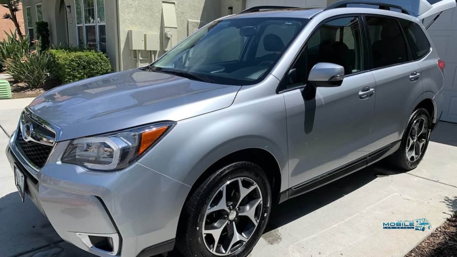 rofessional car detailing cost in San Diego - transformation of a Subaru in a driveway
