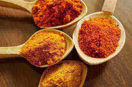 Fresh turmeric root and curcumin powder displaying the golden color of this powerful natural compound