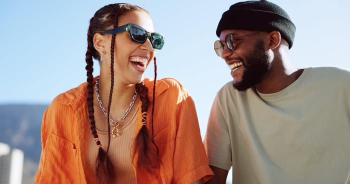 Couple smiling at each other on a sunny day. 