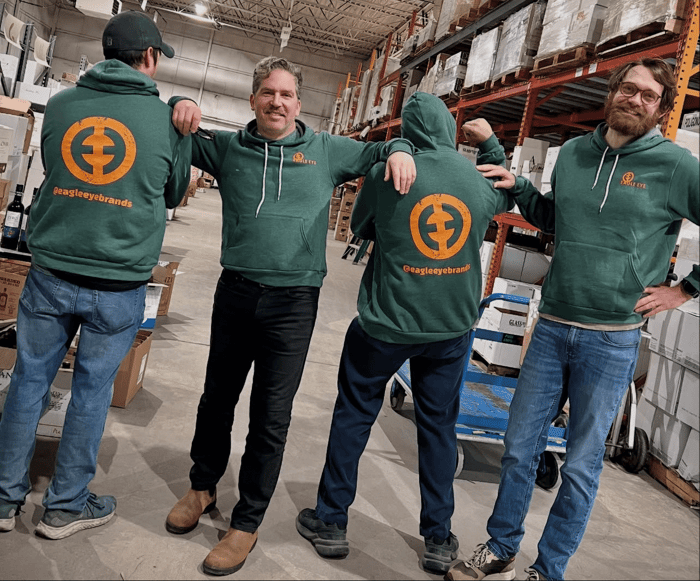 4 warehouse workers in custom hoodies