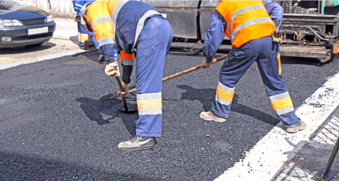 Two construction road workers in custom gear